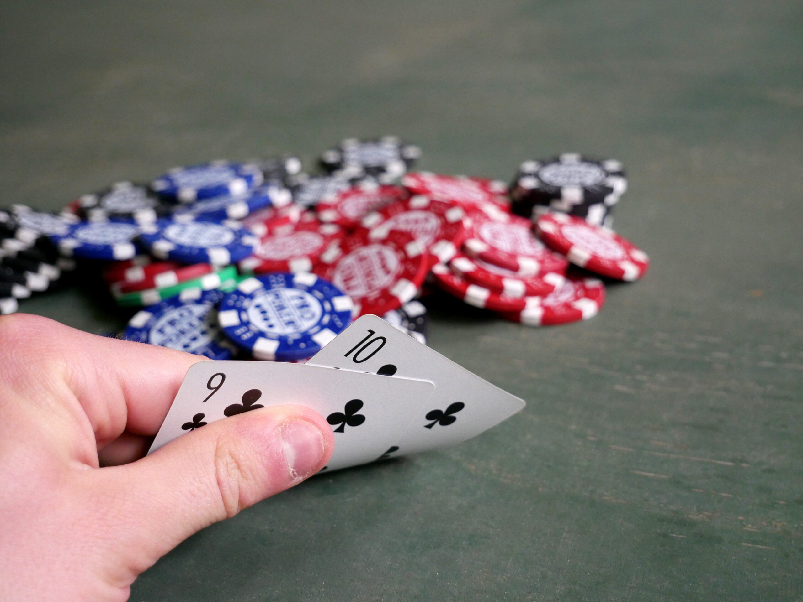 Poker cards and chips on a green felt table